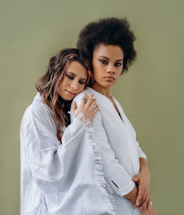 Woman performing a gentle yoga stretch in a calm, minimalist environment.
